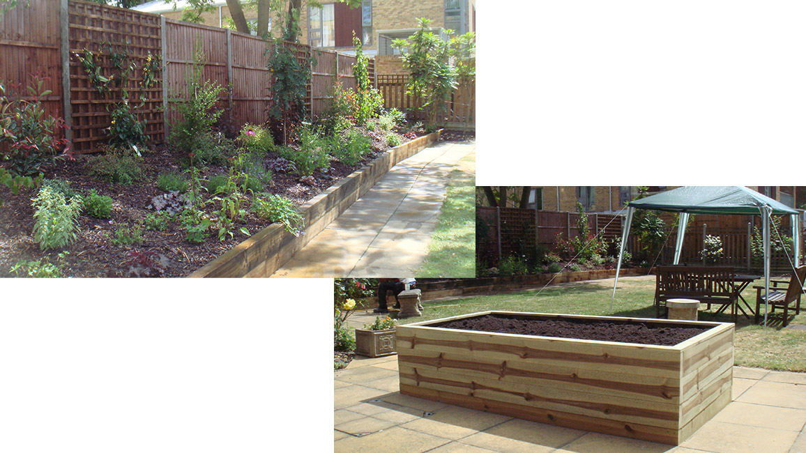 A raised bed full of flowers next to a fence with a trellis