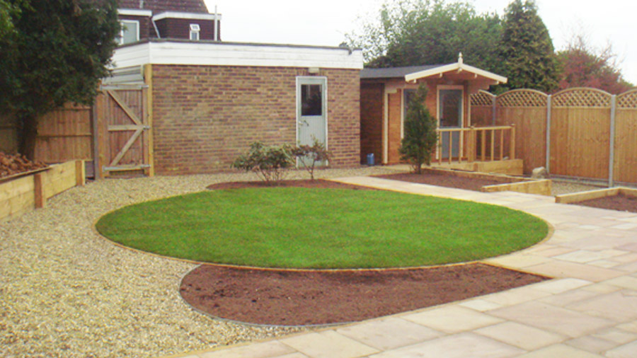 bedding and paving leading up to the right hand fence